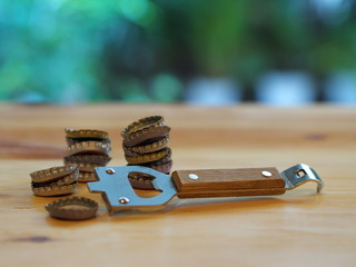 Bottle Opener with a cap on a wooden table. Natural Light.