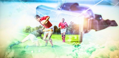 Composite image of rugby players tackling during game