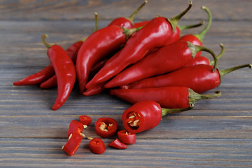 Red hot chili peppers on old wooden table