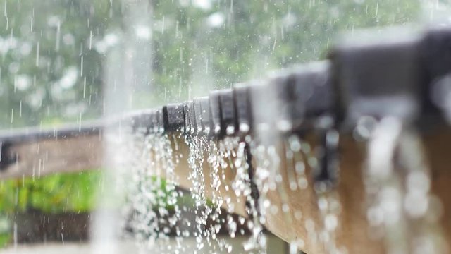 Rain drops fall continuously from a roof in the rainy season