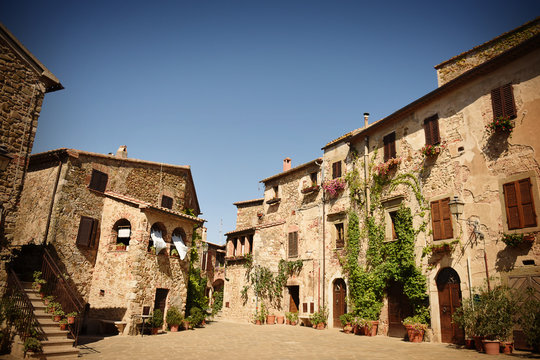 Main square of the medieval village Montemerano in summer. Tuscany, Italy