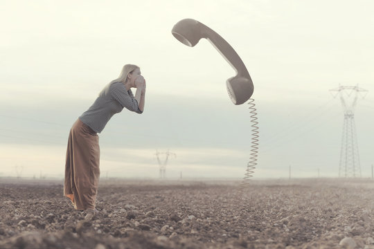surreal moment between a woman screaming in a huge phone connected to the ground