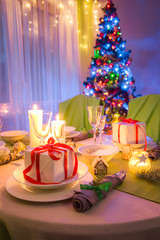 Traditionally Christmas table setting with candles and gingerbread