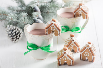 Small gingerbread cottages with tasty cocoa as Christmas snack