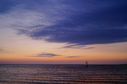 Windsurfing on the sunset at the sea