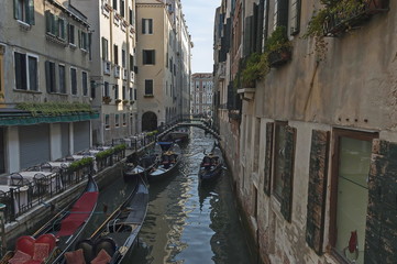 Fototapeta na wymiar Traditional gondola ride in small canal at residential district of historical buildings and bridge, Venezia, Venice, Italy, Europe 