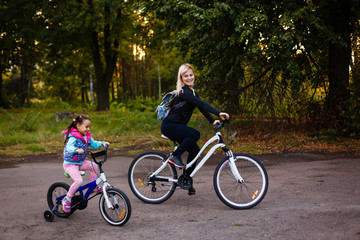 Mother and daughter were cycling at the park