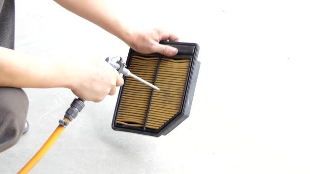 Electric blowers air blowing to car engine filter for cleaning the dust.