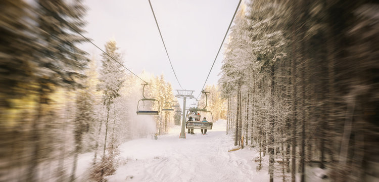 People are lifting on ski-lift in the mountains