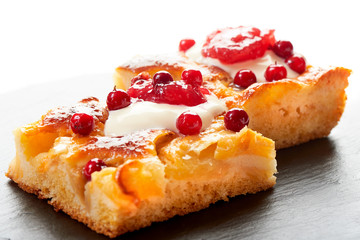 Apple cake with cream, jam and forest berries