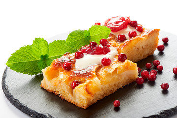 Apple cake with cream, jam and forest berries