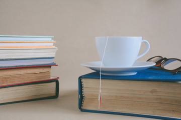 Fototapeta na wymiar Book glasses and tea on the desk with study and education concept