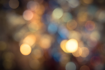 Defocused Christmas city night colorful bokeh abstract for sparkle holiday background. Vintage tone texture.