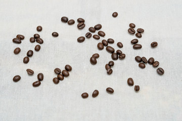 Coffee beans on sackcloth texture background.