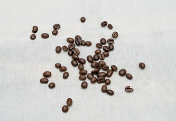 Coffee beans on sackcloth texture background.