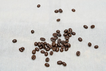Coffee beans on sackcloth texture background.