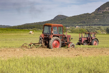 Old tractor working on the field