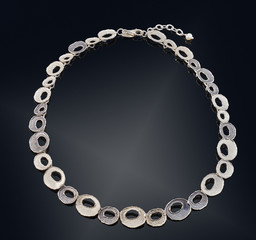 Golden necklace with isolated on black