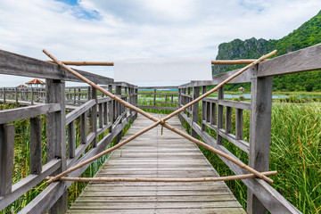 Obraz premium Wooden pathway on lake with no entry sign