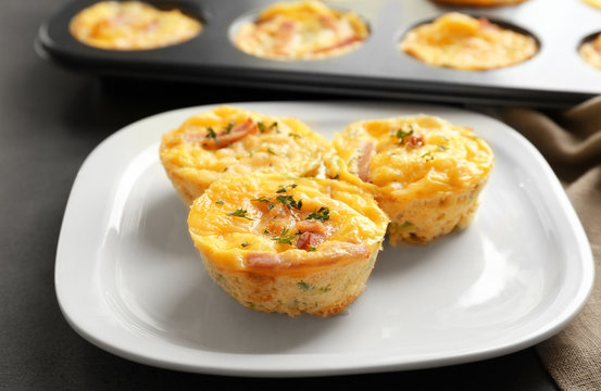 Plate with tasty egg muffins on table