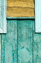 Ancient vintage wooden texture. Colored green, yellow, blue wall. Cracked paint. Grunge colored background for design. Stock Photo