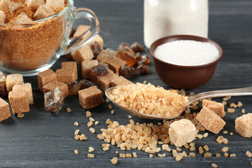 Different kinds of sugar on grey table