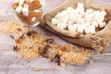 White and brown sugar on wooden table