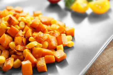 Carrot salad with corn on plate, closeup