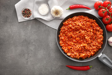 Meat sauce in frying pan on kitchen table