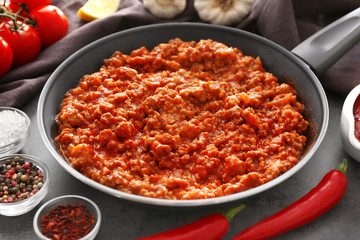 Meat sauce in frying pan on kitchen table