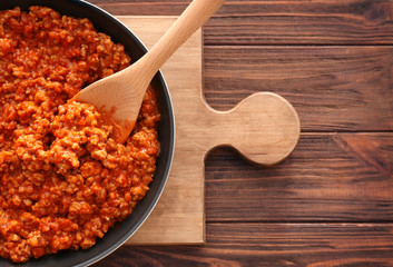 Meat sauce in frying pan on kitchen table