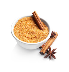 Bowl with cinnamon sugar and sticks on white background