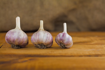 Garlic cloves on wooden vintage background.