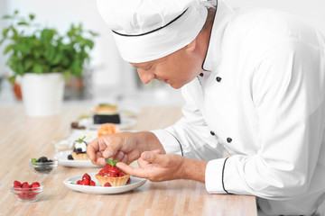 Male chef cooking dessert in kitchen