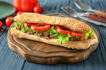 Delicious steak sandwich on table