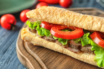 Delicious steak sandwich on table