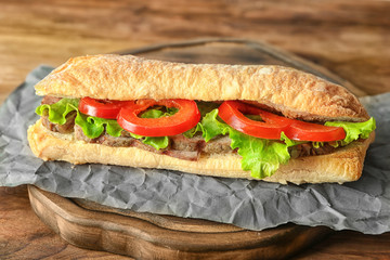 Delicious steak sandwich on table