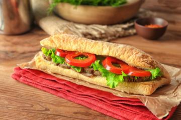Delicious steak sandwich on table