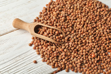 Scoop and healthy lentils on wooden background