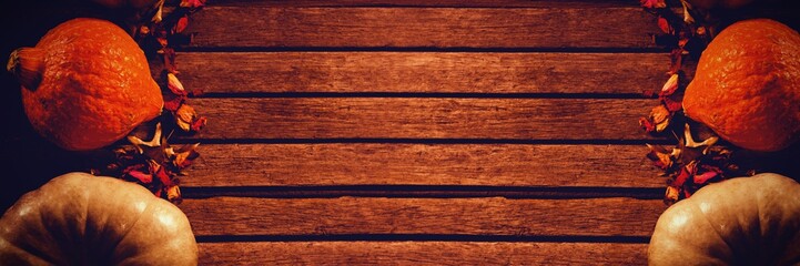 Naklejka premium Pumpkins with dried petals on table