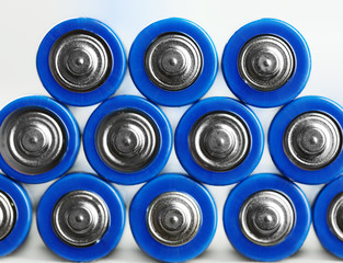 Many used batteries on white background