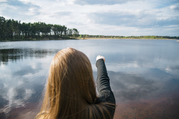 Woman Pointing at Lake - 174503920