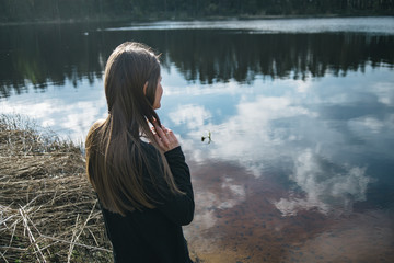 Young Woman Looking at Lake - 174503923