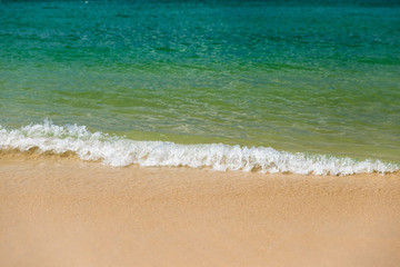 Fototapeta na wymiar Beautiful gentle wave and sandy at the shallow beach