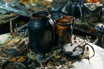 Kitchen utensils in burned by fire house, burned furniture