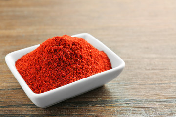 Superfood powder in bowl on wooden table