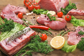 Different types of meat on wooden table