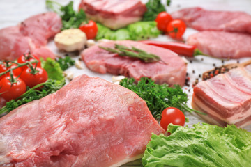 Different types of meat on wooden table
