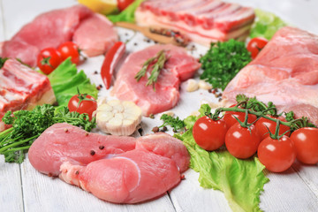 Different types of meat on wooden table