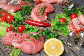 Different types of meat on wooden table